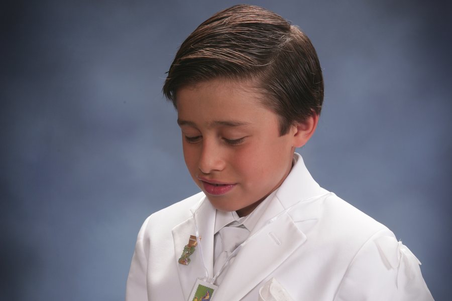 Boy in a white First Communion suit